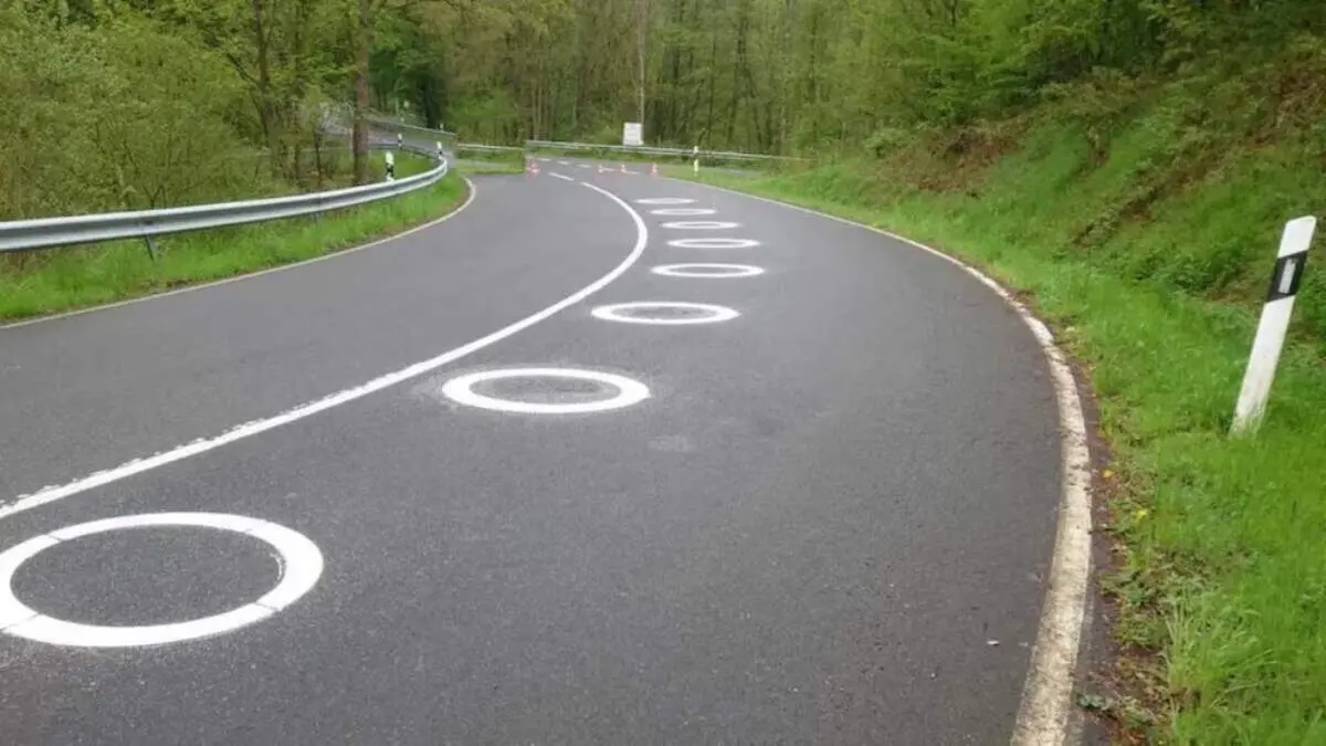 Cercles blancs de la DGT per protegir motoristes en corbes perilloses i reduir accidents de tr&agrave;nsit &mdash; Imagen generada por IA