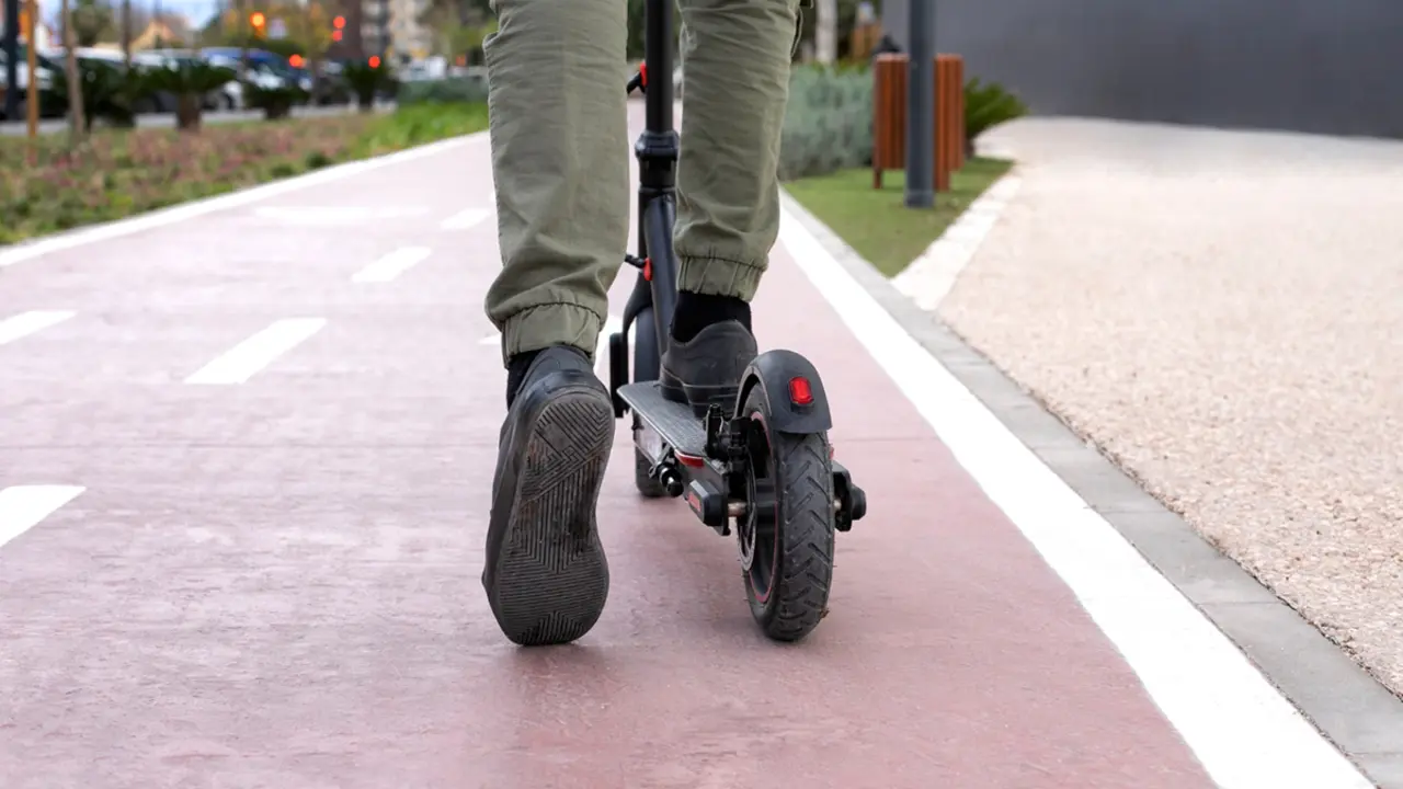 Joves preferint patinet i bici davant de la moto