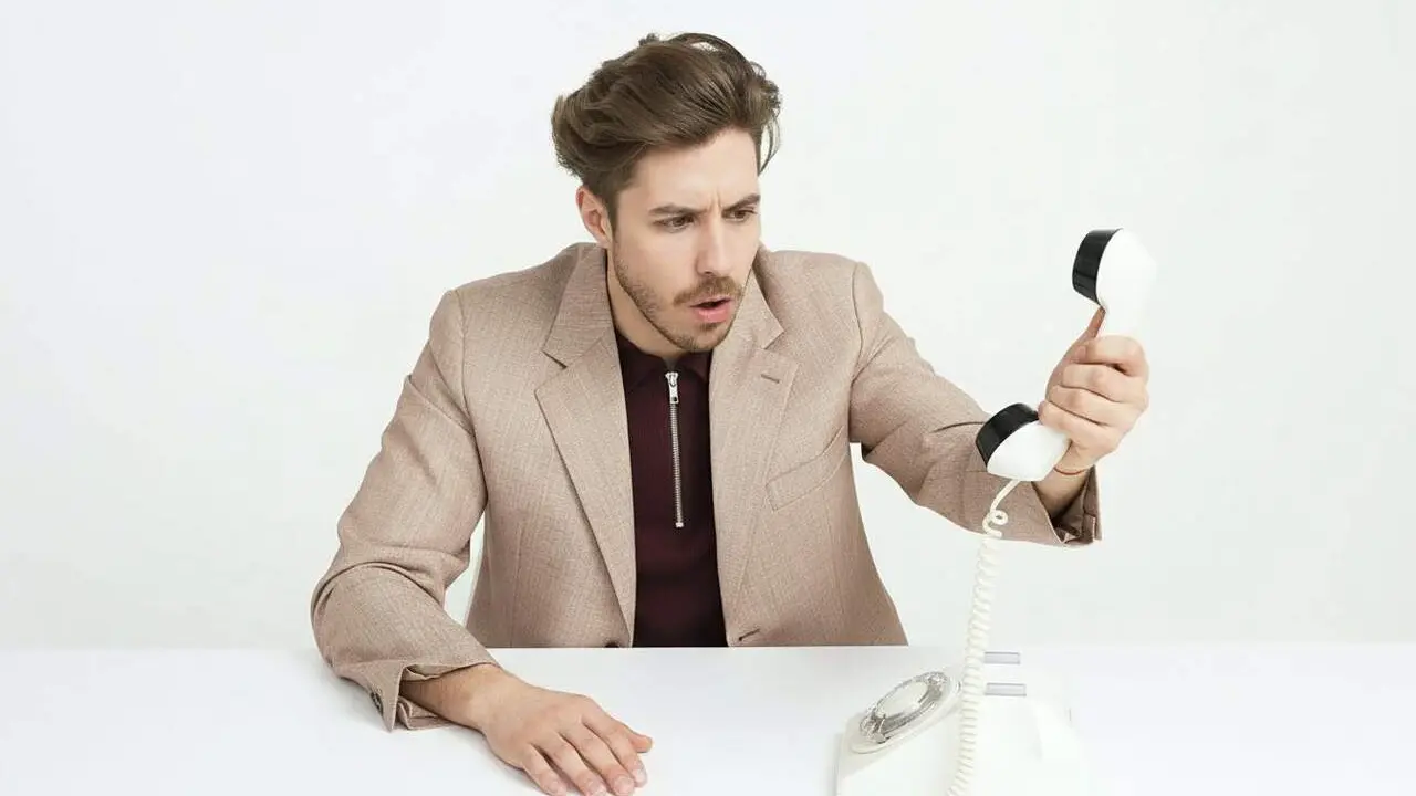  Usuari penjant el tel&egrave;fon amb precauci&oacute; per reduir les trucades spam telef&ograve;niques i millorar la seguretat personal &mdash; Imagen generada por IA 